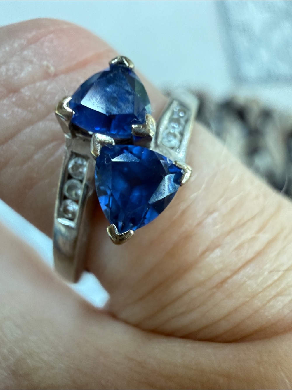 10k white Gold w/6 diamonds inset, 2 Ceylon Sapphires trillion cut app .60-80ctw